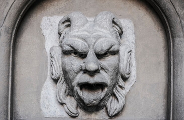  look at one of the carved stone. Demon heads on top of building.open mouth with protruding tongue. evil eyes