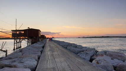 Sea sunrise at the stone pier