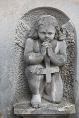 Fototapeta na wymiar Tomb angel relief at Lychakiv cemetery in Lviv, Ukraine
