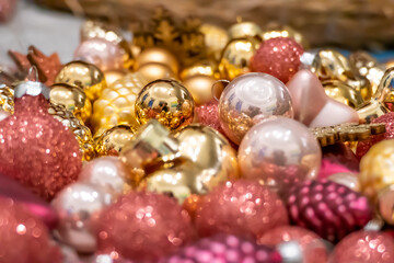 Golden and pink pink Christmas decorations lying around