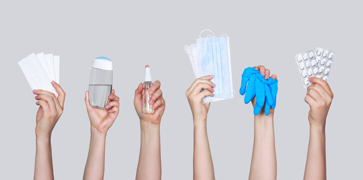 Set of antiseptic items. Hands holding bottles of antiseptic hand gel and spray, medical gloves, couches and wearing mask on blue background. Flu, illness, pandemic concept