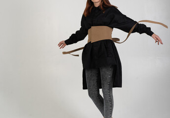 girl with a wide belt on a white background, unrecognizable