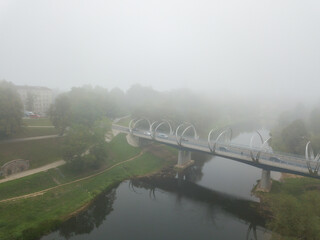 misty morning in the fog bridge over the river Gauja covered in the mist