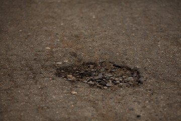 pits and holes in the asphalt road