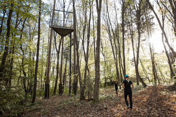 Amusement park with rope jumping tower in the forest