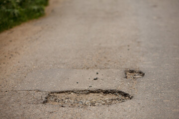 pits and holes in the asphalt road