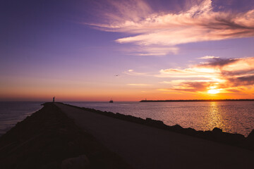 sunset on the beach in the Atlantic ocean Viana do Castelo Praia do Cabedelo Cabedelo beach colorful clouds with a lighthouse