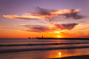 sunset on the beach in the Atlantic ocean Viana do Castelo Praia do Cabedelo Cabedelo beach colorful clouds with a lighthouse