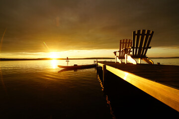 Fototapeta na wymiar Stand up paddle boarding in Haliburton, Ontario at sunset
