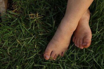 pies de niña sobre pasto