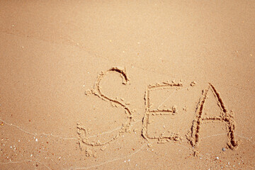 Handwritten Sea Word on the Sand Coast. Wonderful words on beach sand. Love idea concept.