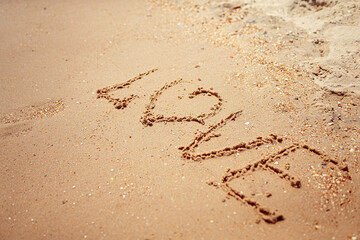 Handwritten Love Word on the Sand Coast. Wonderful words on beach sand. Love idea concept.