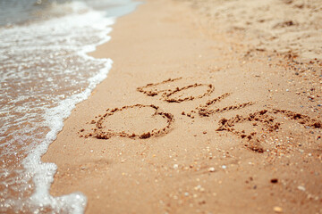 Handwritten Love Word on the Sand Coast. Wonderful words on beach sand. Love idea concept.
