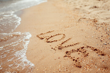Handwritten Love Word on the Sand Coast. Wonderful words on beach sand. Love idea concept.