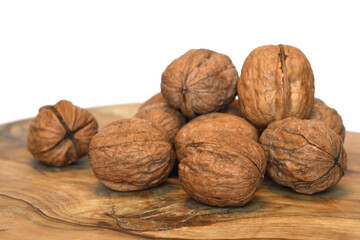 closeup on walnuts on wood and white background