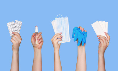 Set of antiseptic items. Hands holding bottles of antiseptic hand gel and spray, medical gloves, couches and wearing mask on blue background. Flu, illness, pandemic concept