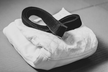 Black judo, aikido or karate belt on white judo gi