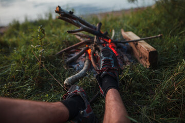 legs on the background of a campfire