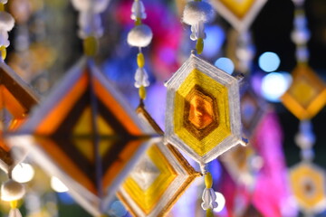 Hanging handmade hexagonal colorful knitting yarn flags suspended from bamboo pole for decoration and celebrating Colorful drape, Blown in the traditional Buddhist beliefs. In Thailand, Myanmar, Lao.