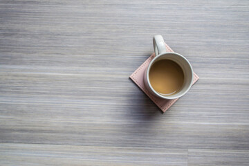 Cup of coffee on a coaster