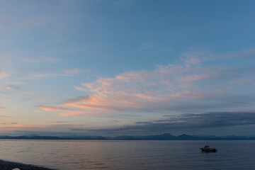 Fishing boats in the ocean at dusk off the coast of Bere Point, Sointula, Malcolm Island, British Columbia