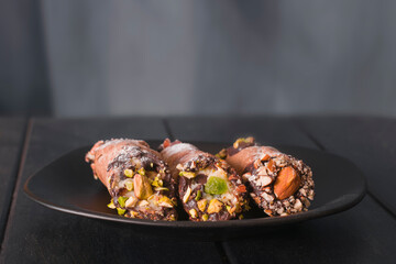 Cannoli, Italian dessert made of cream cheese, pistachio and almonds