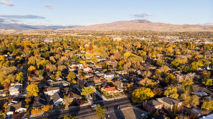 Drone  photo of Reno neighborhoods during the fall sesason looking towards the mountains.