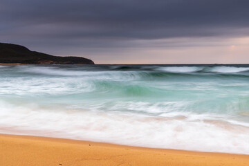 Low cloud filled sky and sunrise seascape