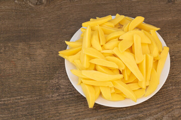 A plate full of sliced potatoes ready for baking