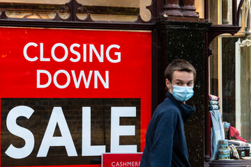 Closing Down Sale poster on a clothing store window due to covid-19