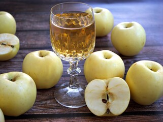 Apple juice and yellow apples fruit on wooden background	