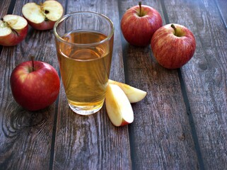 Apple juice and yellow apples fruit on wooden background	