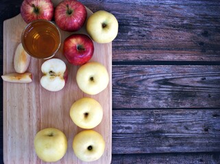Apple juice and yellow apples fruit on wooden background	