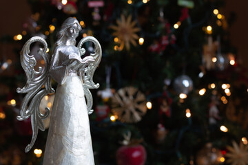 Angel Statue in front of Christmas tree