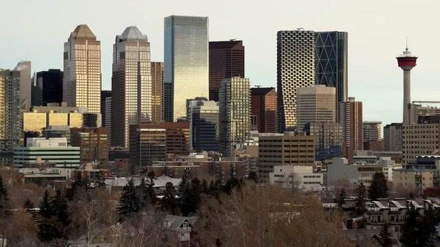 The City of Calgary downtown oil and gas office district with morning sunrise building reflections.