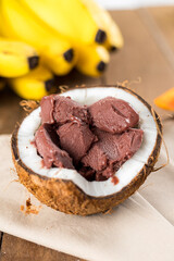 Brazilian Açai on a coconut shell with a wood background and fruits