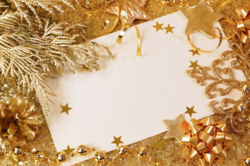New Year card framed with gold tinsel and Christmas tree decorations. Place for text - 395847687