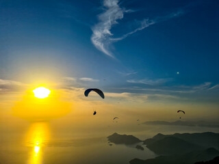 Beautiful view of golden hour sunset with paragliders