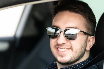 Portrait of a Man Driver in His Car