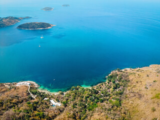 Wonderful and breathtaking top view of an isolated beautiful tropical island with a beach and blue clear water