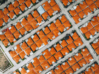 Aerial view from a drone lined up roofs of houses red-tiled. Beautiful landscape