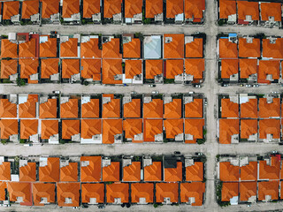Aerial view from a drone lined up roofs of houses red-tiled. Beautiful landscape