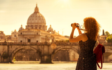 Girl tourist takes photo of sunny Rome, Italy, Europe. Travel concept.