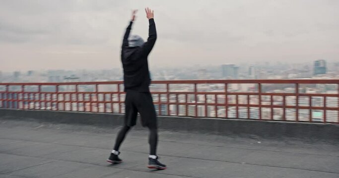 Fitness workout on roof on cloudy day in city