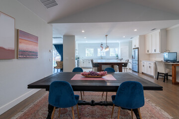 Open floor plan of dining room to kitchen, white, blue, modern, updated