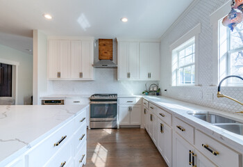 White quartz kitchen with cedar vent, windows, black and gold fixtures - obrazy, fototapety, plakaty