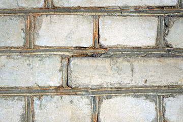 Old white wall with sand-lime brick with gray cement ties