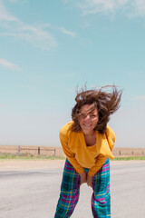 Portrait of romantic happy female with blowing hair enjoy weather and sunny day outside. Portrait of beautiful young woman smiling with windy hair on face. People, lifestyle