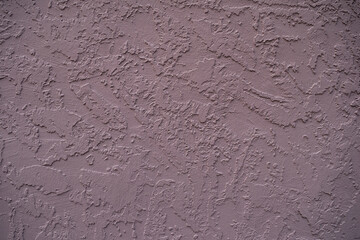 Textured mauve stucco wall