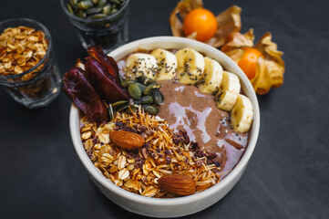 Healthy breakfast. smoothie bowls with fruits, nuts, seeds and homemade granola, banana for healthy vegan vegetarian.